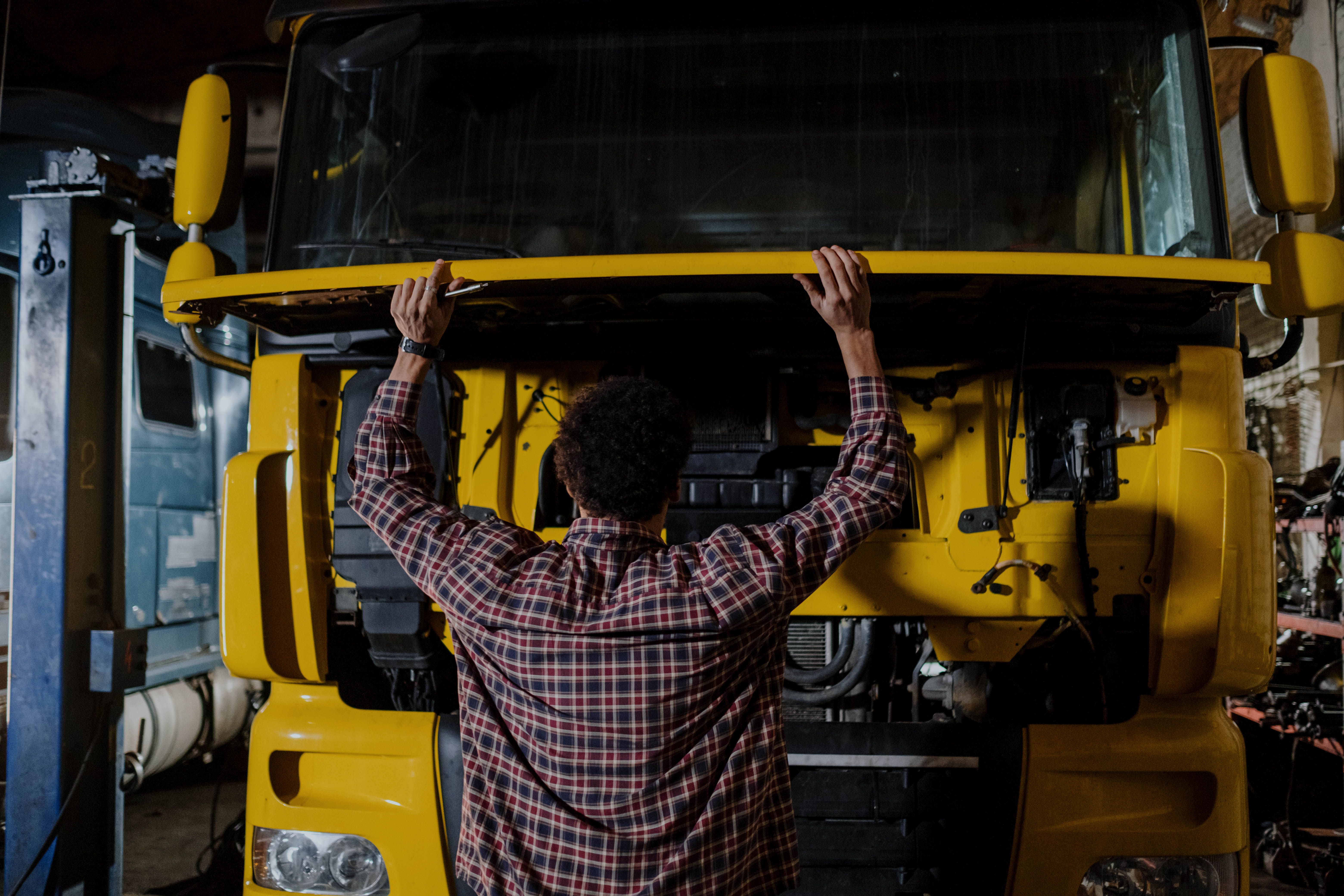 Mechanic inspecting a truck wheel in a workshop